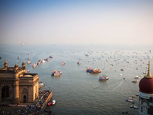 An aerial view of the Gateway to India with boats and fishermen in the background